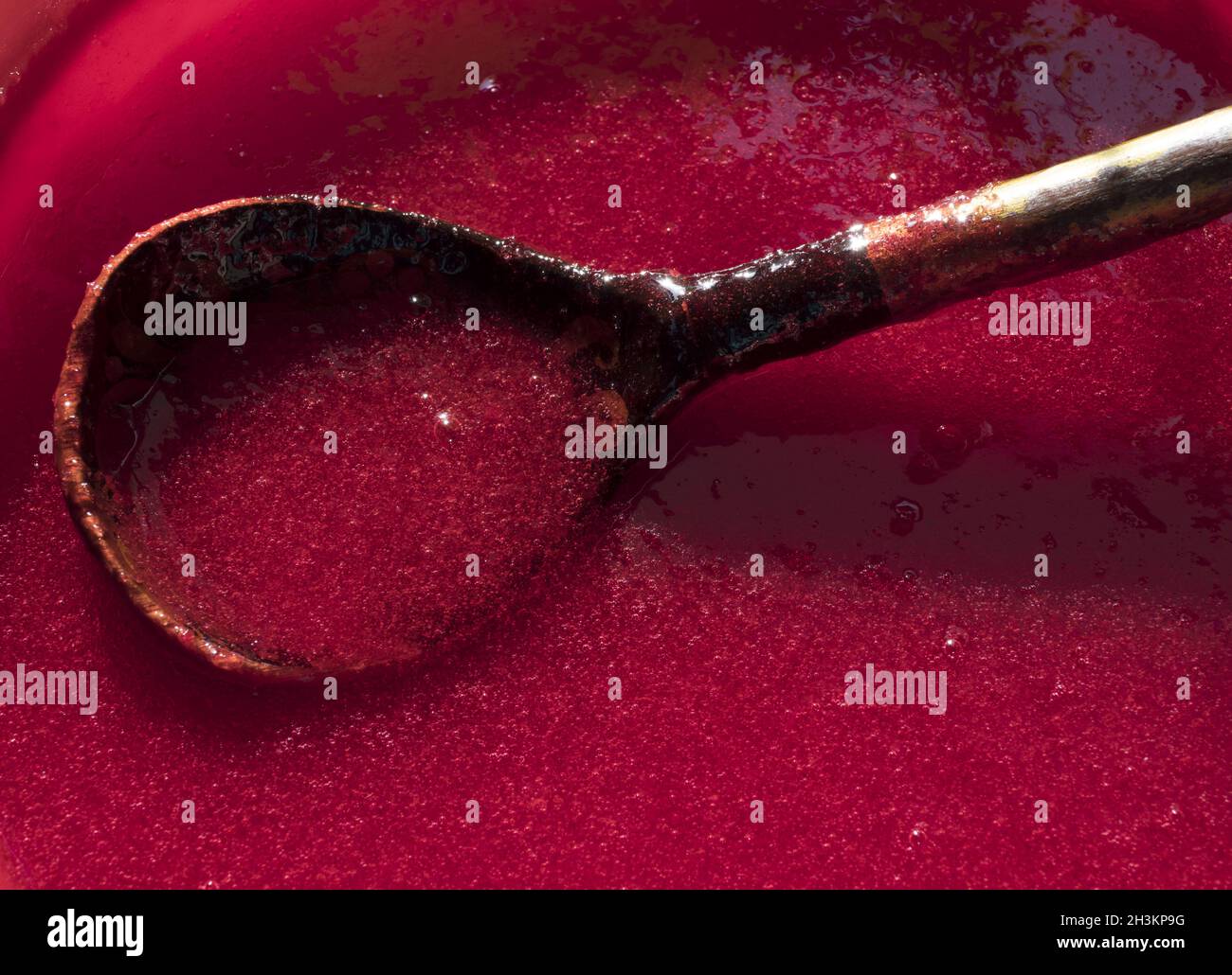 Making juice from viburnum berries at home. Process of making red sweet