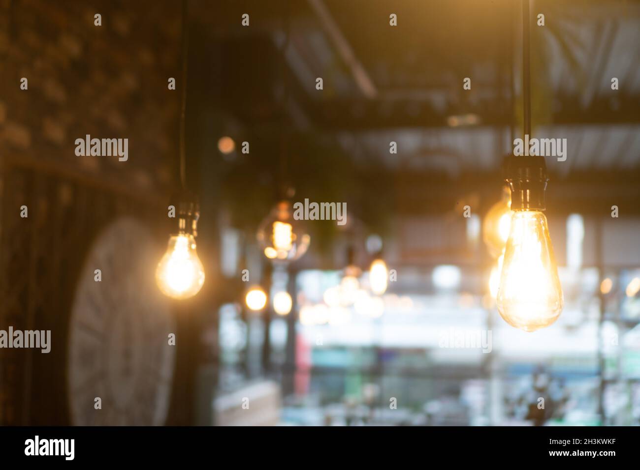 Burning retro light bulbs in restaurant or coffee shop Stock Photo