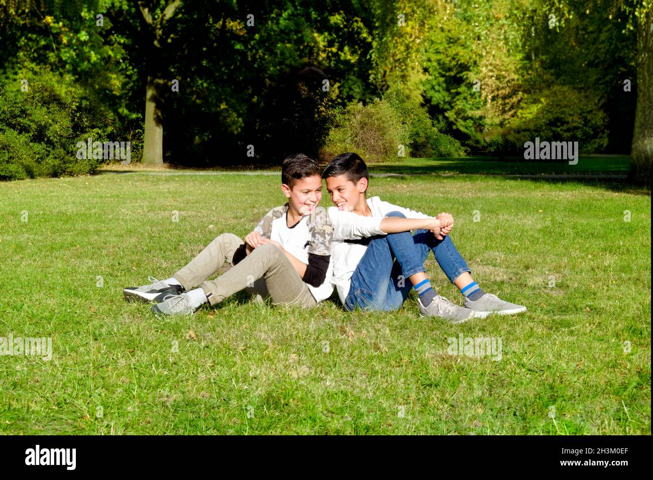 Mother and teenage children in walking the park Stock Photo