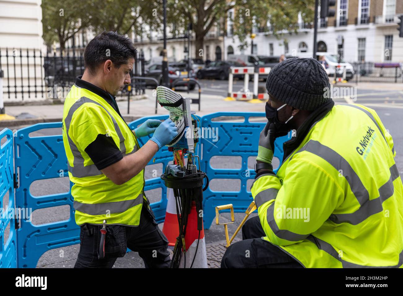 engineers connecting fibre broadband network