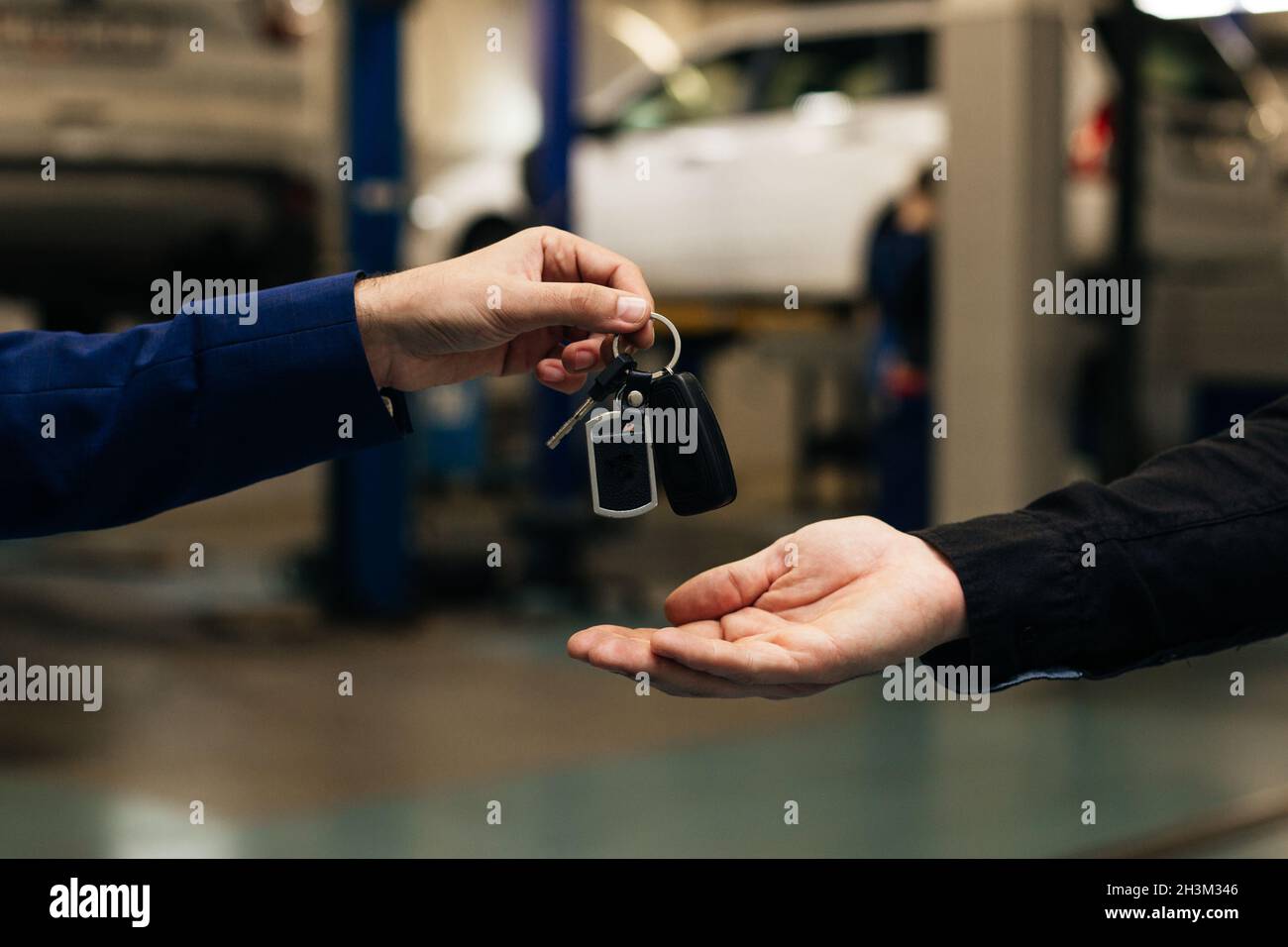 Car key handover, a transport ownership or leasing concept Stock Photo
