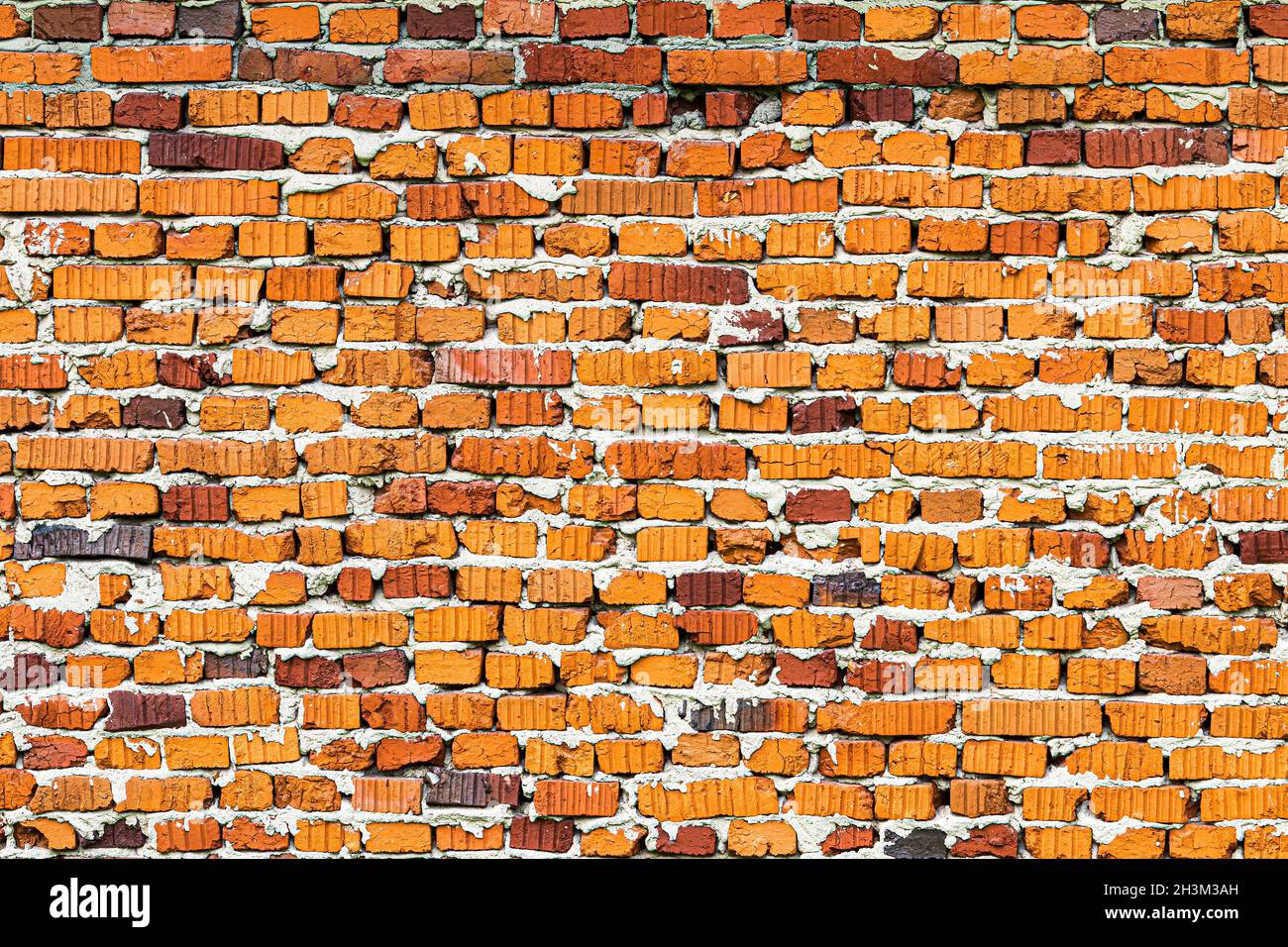 Wall texture from red old damaged bricks. Abstract background for design. Stock Photo