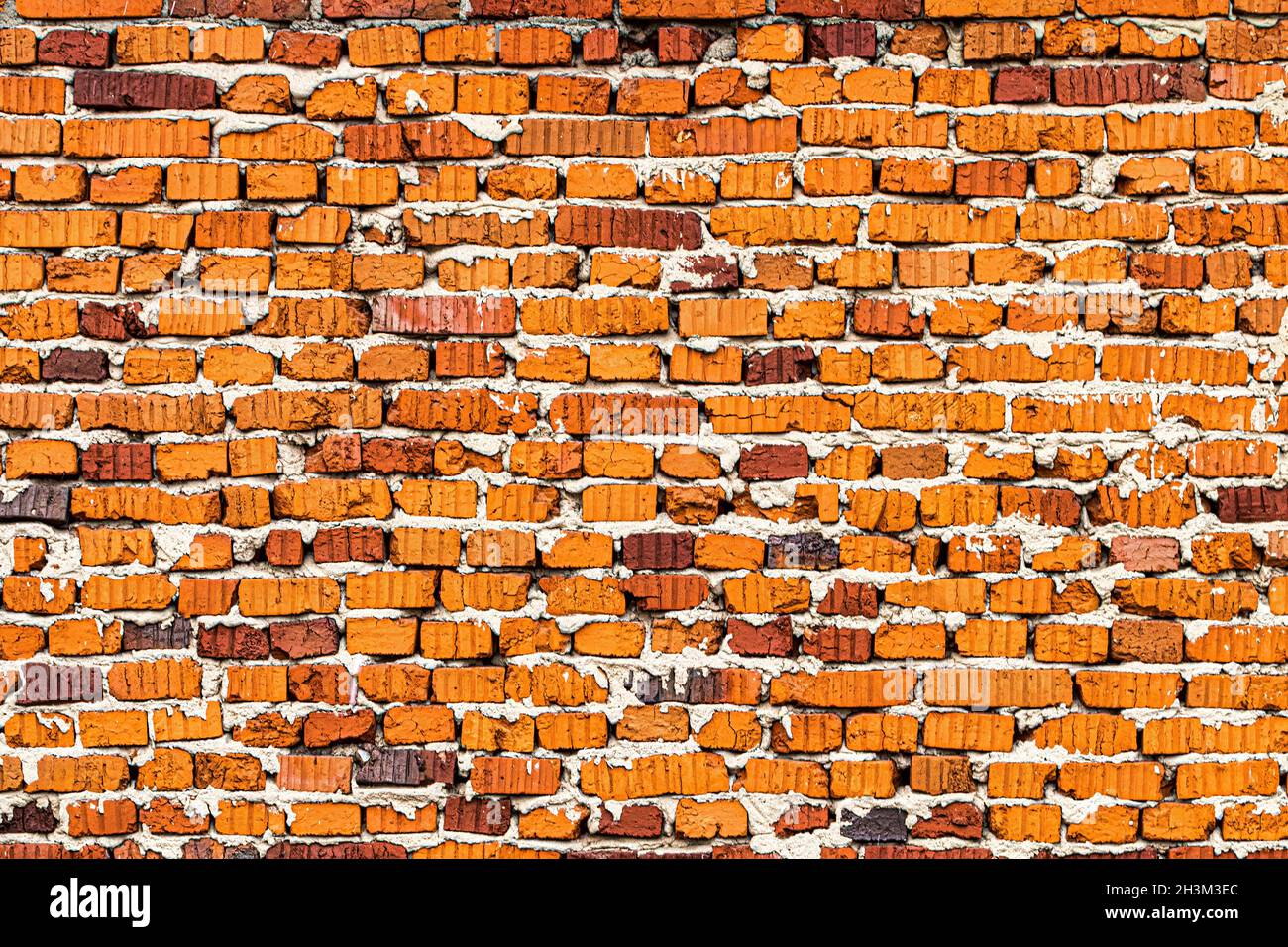 Wall texture from red old damaged bricks. Abstract background for design. Stock Photo