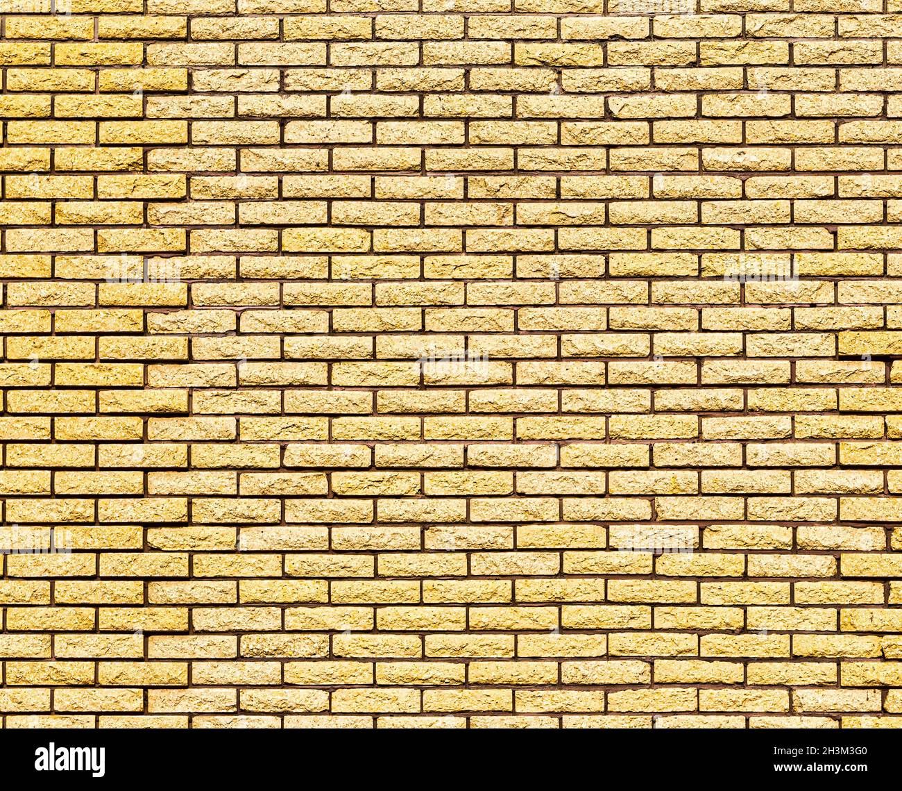 Yellow decorative brick wall texture. Abstract background for design. Stock Photo