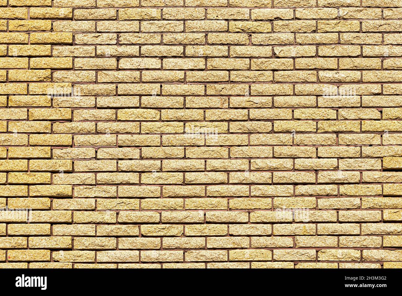 Yellow decorative brick wall texture. Abstract background for design. Stock Photo