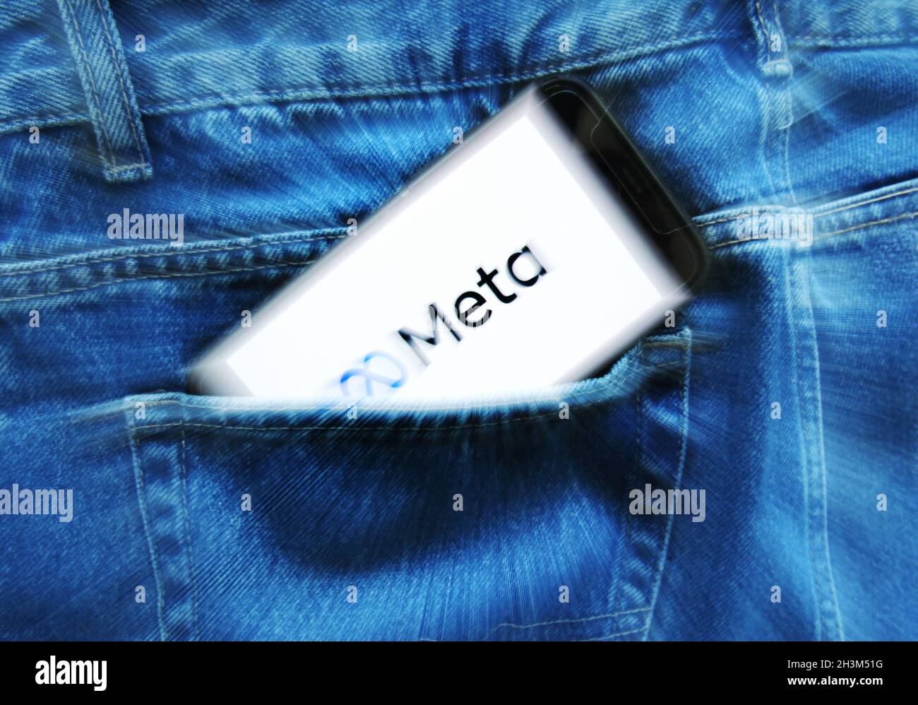In this photo illustration an internet user hold his smartphone in the pants pocket as displays the new logo/name Meta of the social networking of the Facebook on October 29, 2021 in Amsterdam, Netherlands. The Facebook Company's CEO Mark Zuckerberg announced yesterday during the Facebook Connect conference, Facebook changes the name to Meta, the change is to demarcate the company's new phase, which is focused on building a metaverse, a virtual world in which people can interact using augmented reality, virtual reality and other technologies. (Photo by Paulo Amorim/Sipa USA) Stock Photo