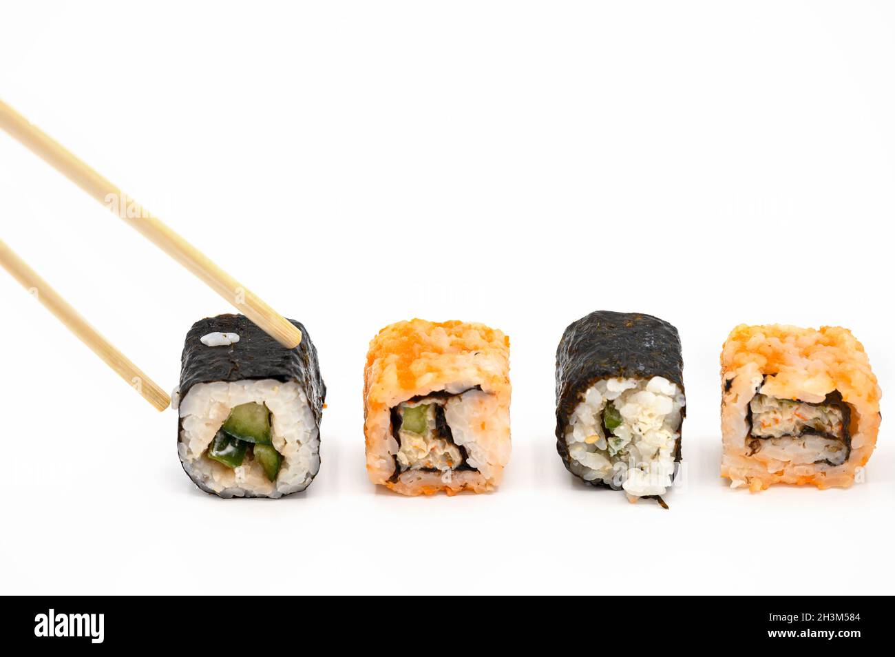Japanese restaurant food. hand pick sushi roll with chopsticks on white isolated background. Stock Photo