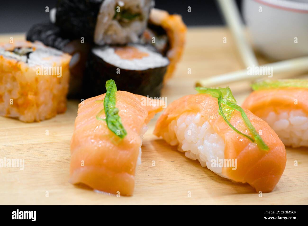 Japanese restaurant food. assorted sushi rolls on black isolated background. Stock Photo