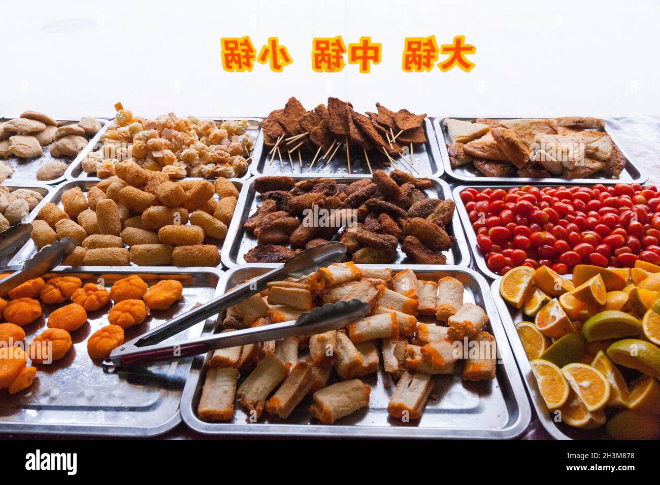 Trays of mixed snacks and snack food, possibly savoury snacks, for sale