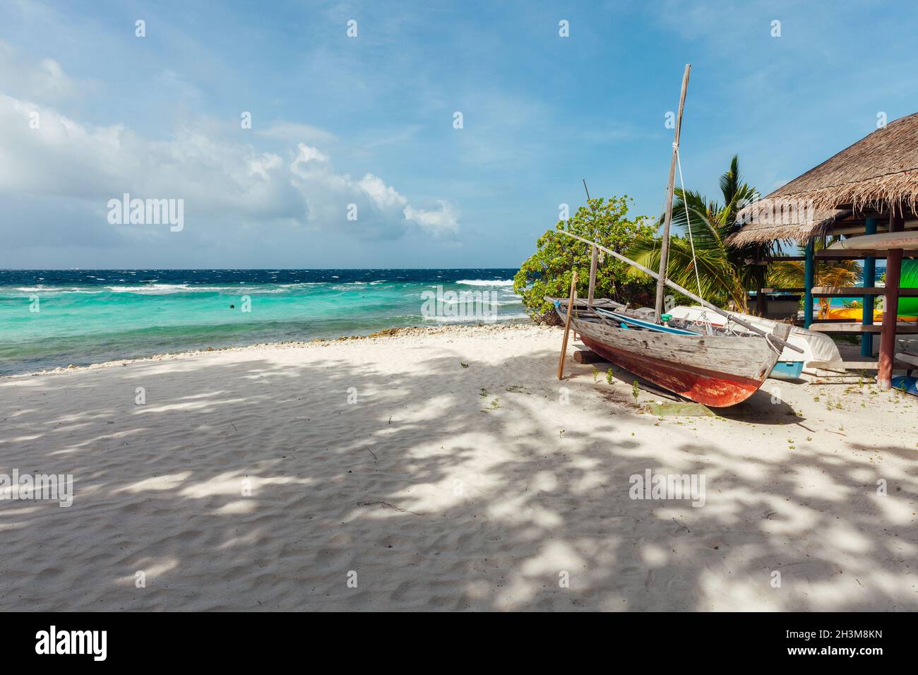 Idyllic beach scene with a traditional boat  in Maldives, North Male Atoll Stock Photo