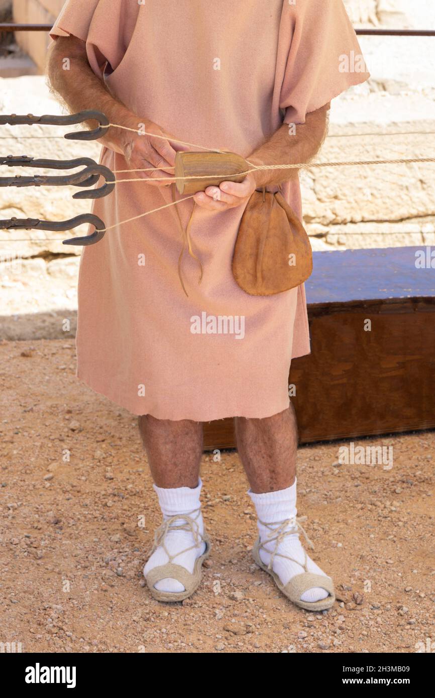 Ancient ropemaker at work. Public demonstration of historical