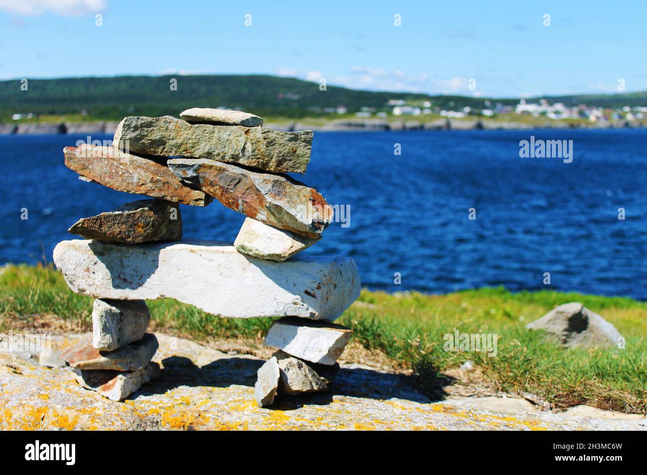 An inukshuk on a hill, overlooking the Ocean, Elliston, Newfoundland Stock Photo