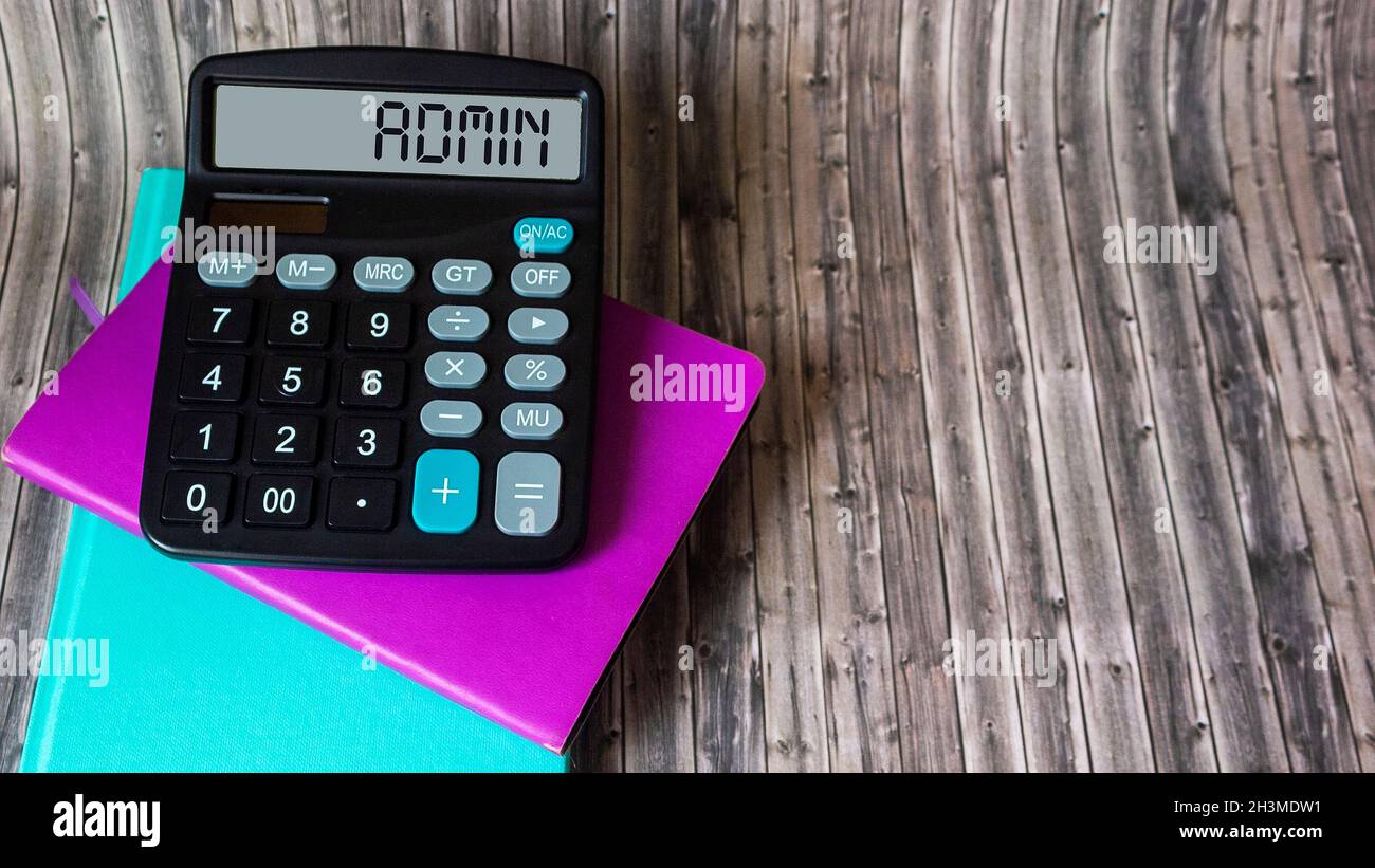 Business term Admin on calculator and wooden table Stock Photo