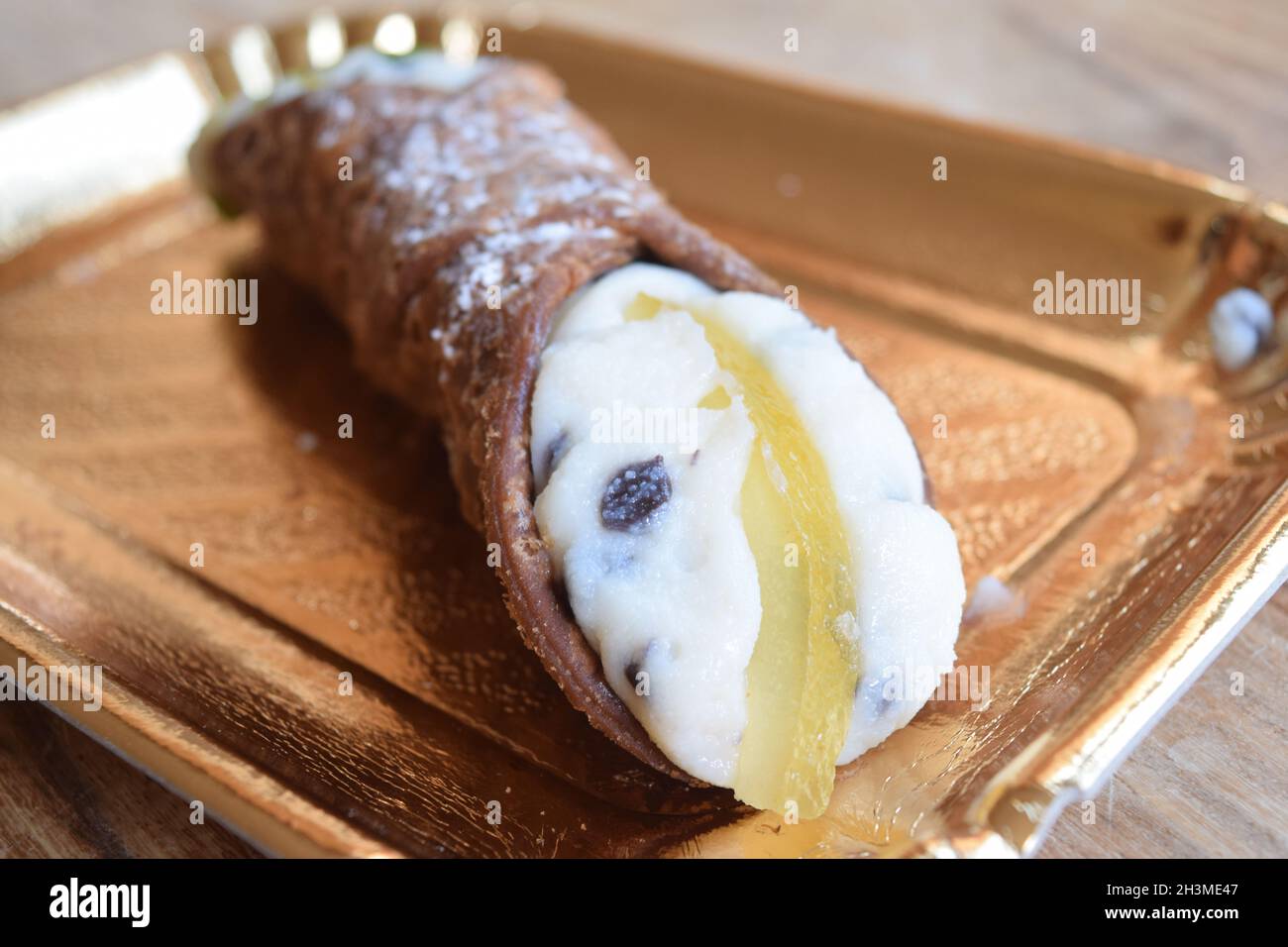 sicilian cannolo stuffed with ricotta cream, chocolate pees and candied