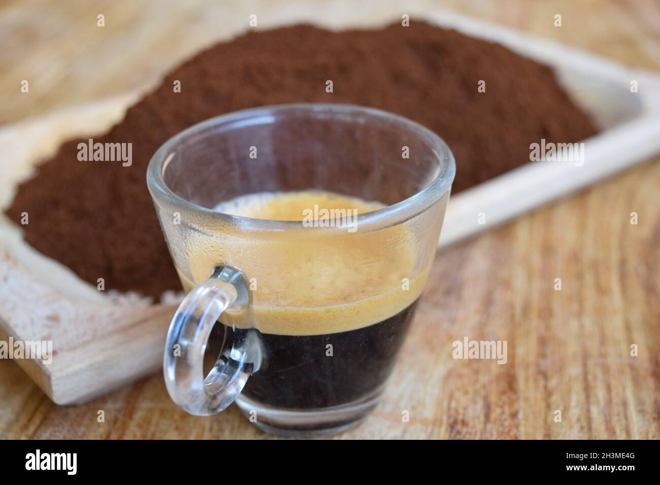 strong and creamy espresso with ground coffee Stock Photo Alamy