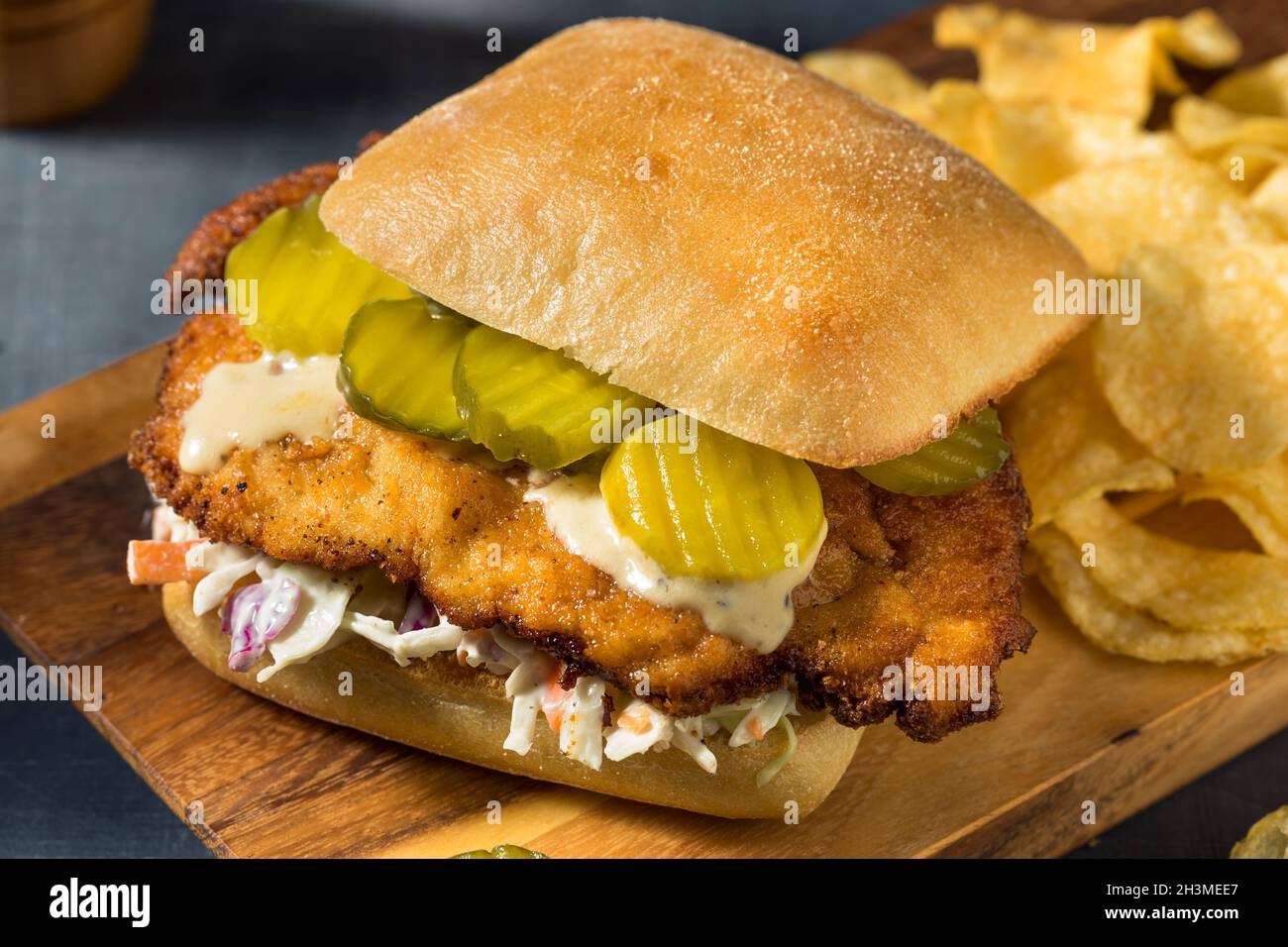 Homemade German Chicken Schnitzel Sandwich with Chips Stock Photo