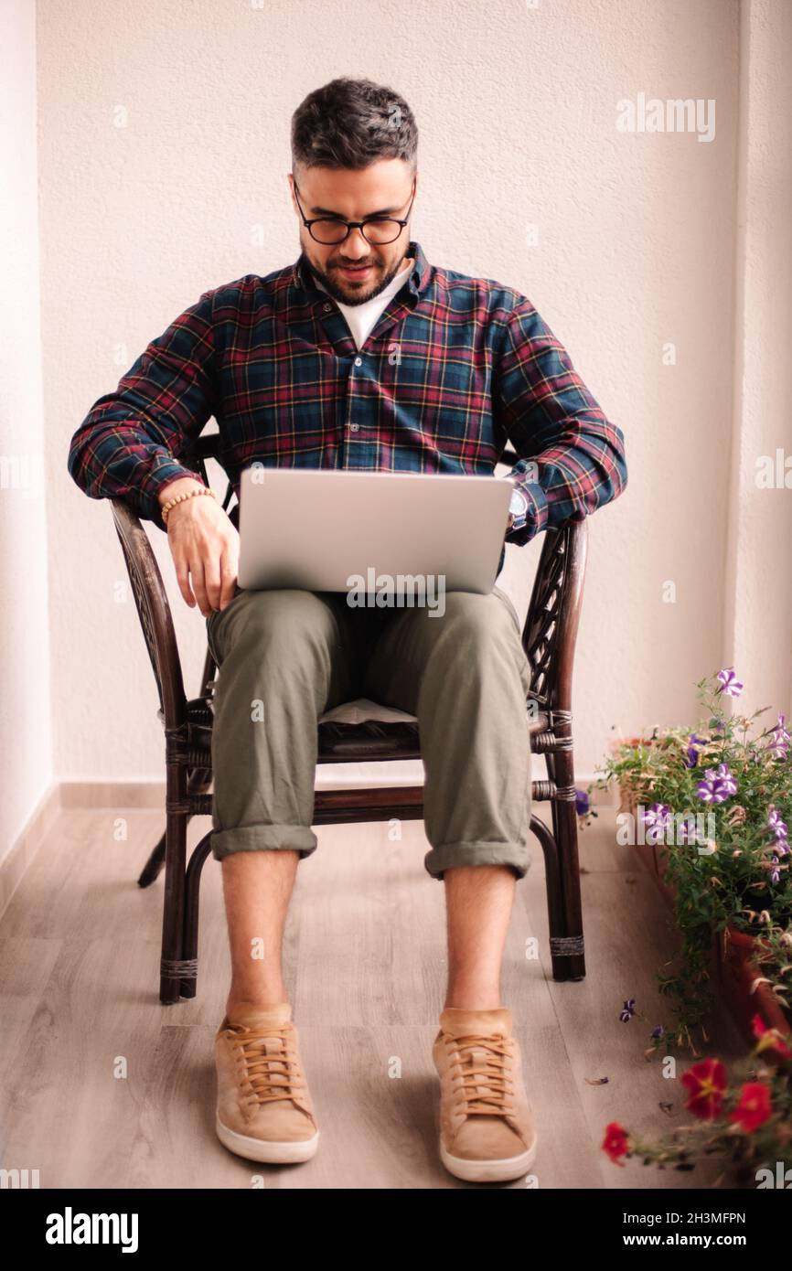Man using laptop computer at home Stock Photo