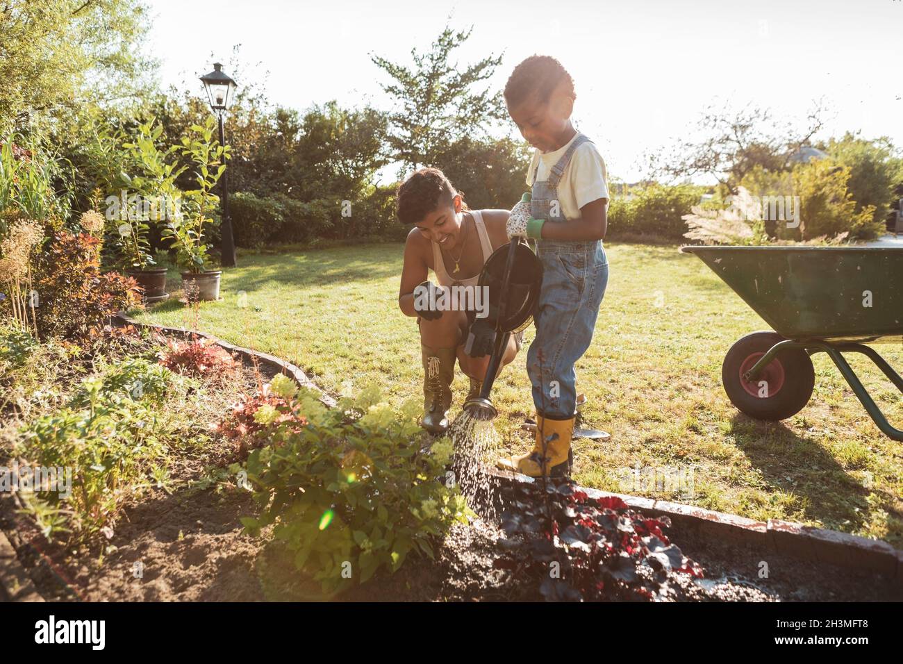 Boy watering plants hi-res stock photography and images - Alamy