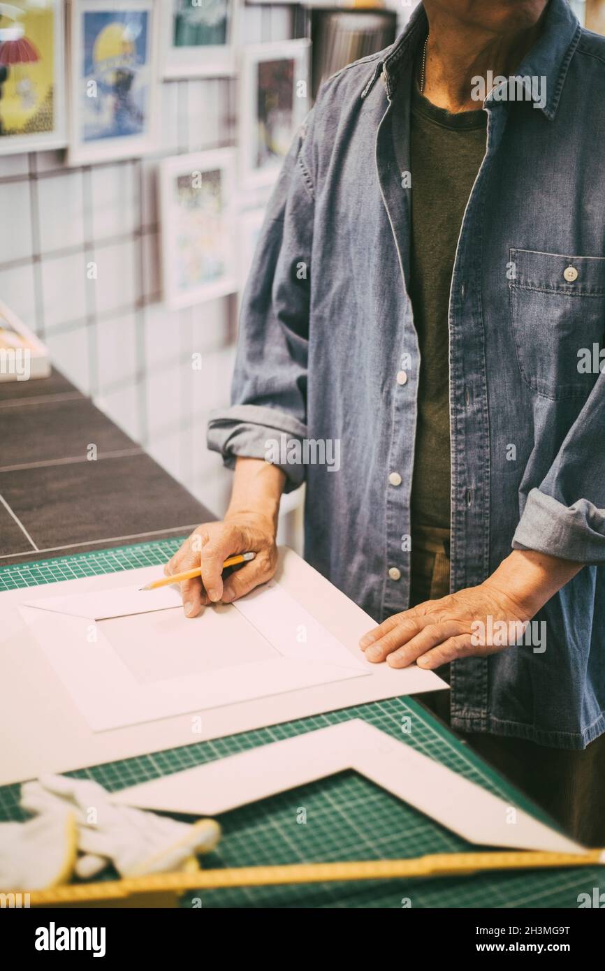 Midsection of craftsman with paper and pencil in retail shop Stock Photo