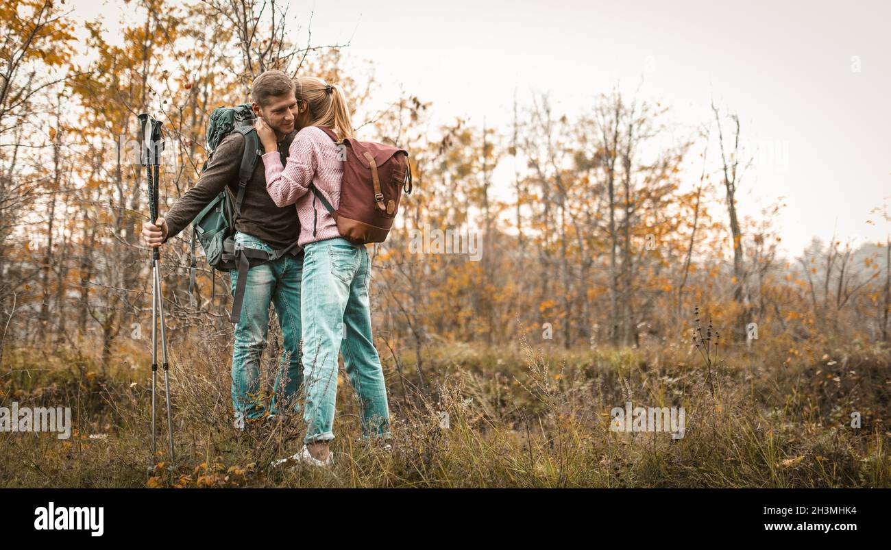 Traveling Couple Stopped To Relax In A Forest Glade Stock Photo
