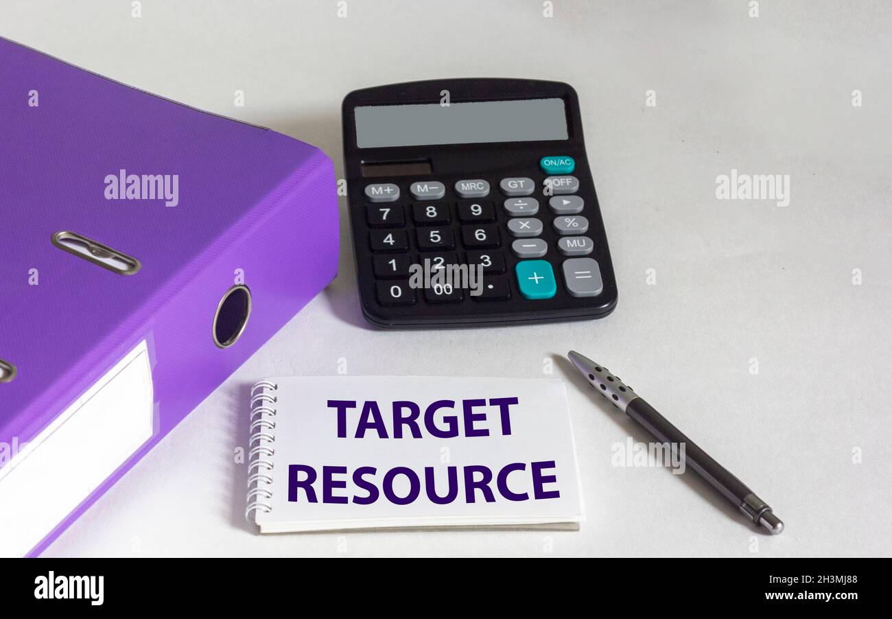 Target resource text on notepad on white background with calculator