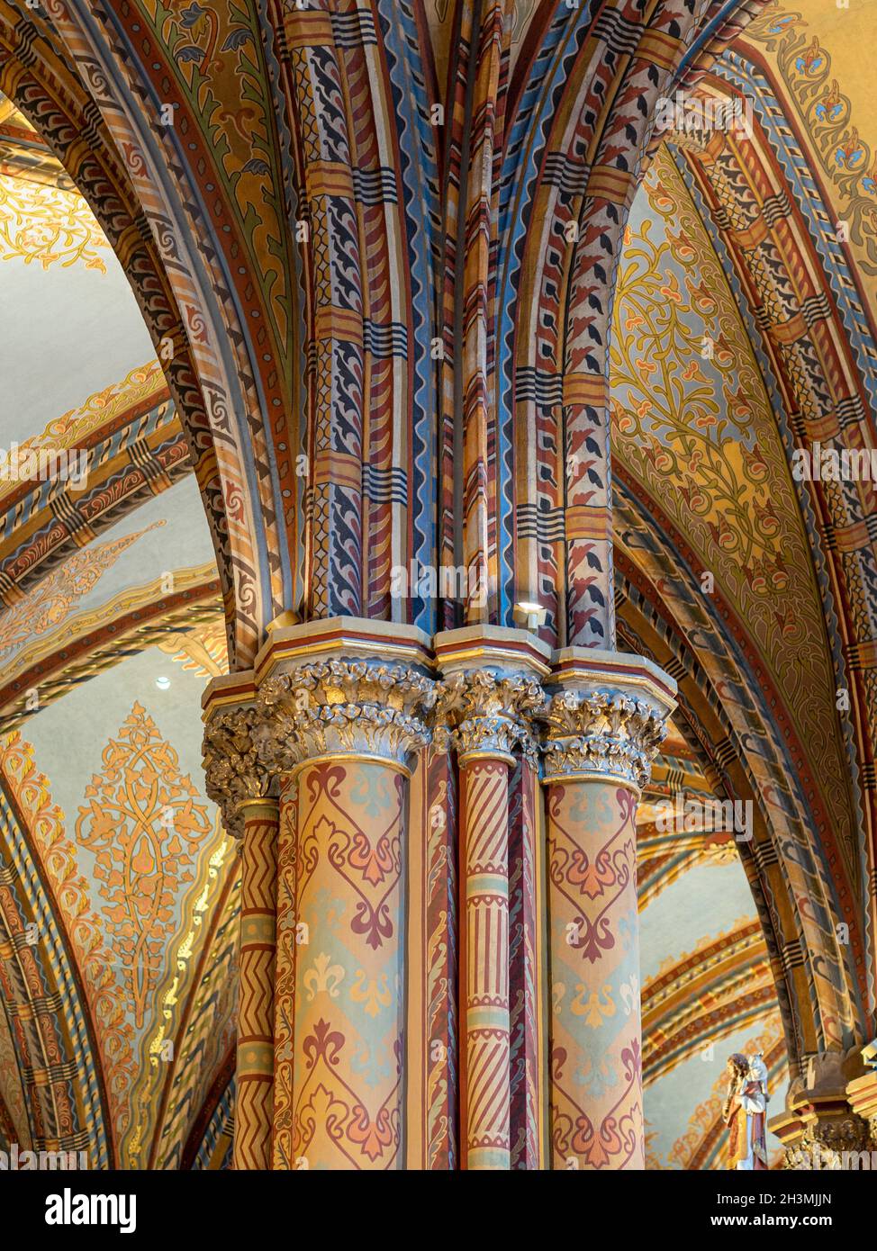 Highly Decorated Column at the Mathias Church: A detailed view of the top of a column and the spreading arch supporting the roof of the Mathias Church in Buda. Stock Photo