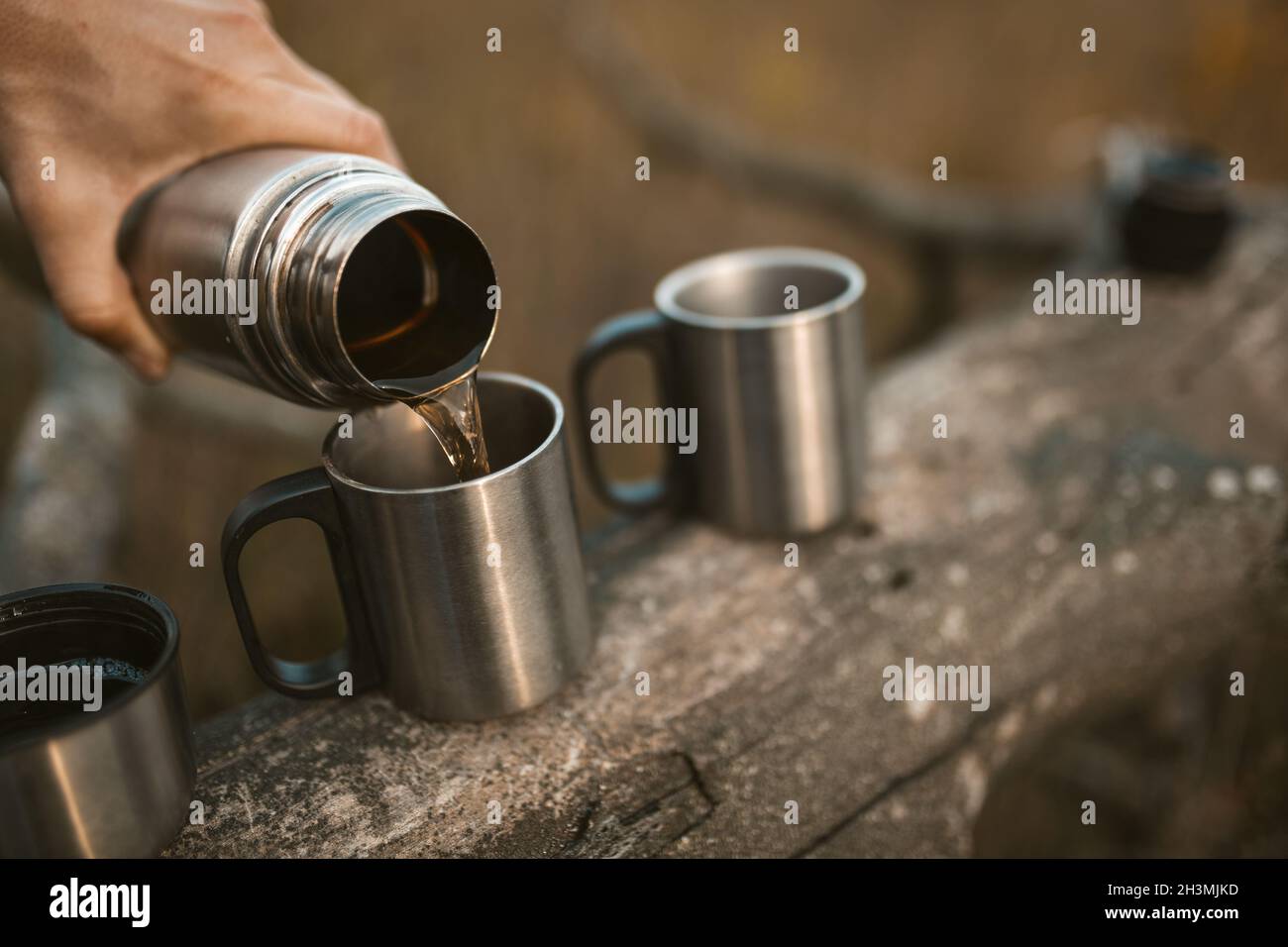 Aluminium Thermos with Hot Drink on Rock Stone Outdoors. Space for