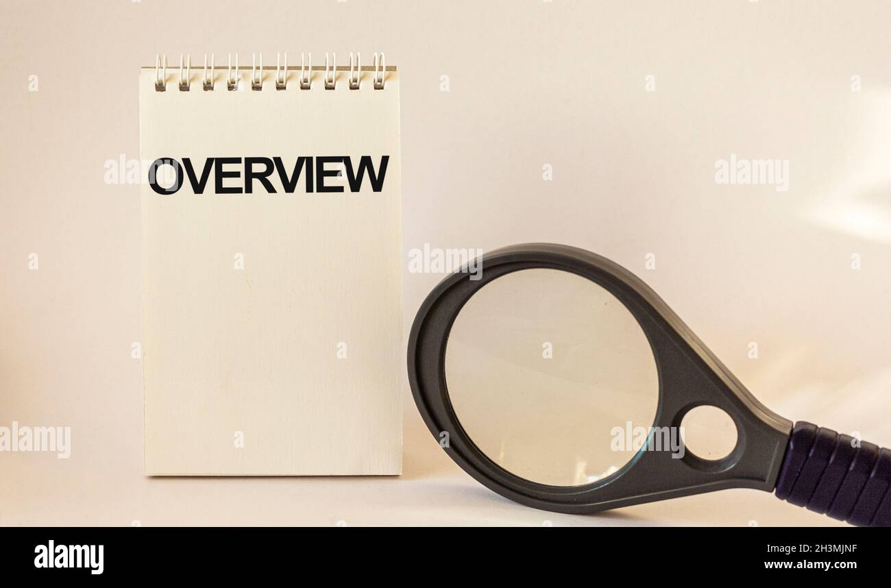 Review, the text is written on the calendar, near a magnifying glass on a white background. Stock Photo
