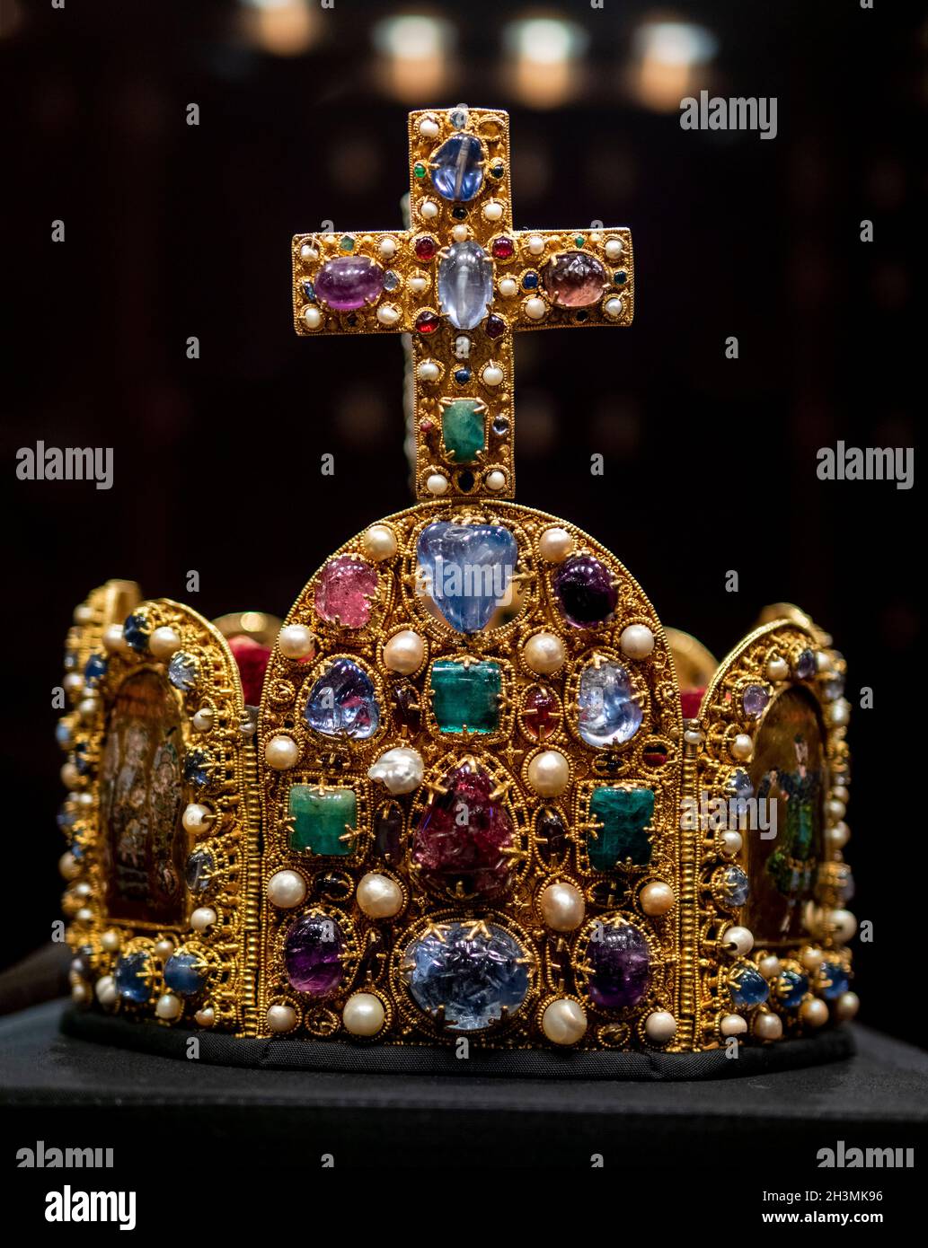 Imperial Crown of the Holy Roman Empire: This heavily jewel encrusted coronation crown was once belived to be the crown of Charlemagne but it was made in the 10th century (c. 962),  150 years after his death. Stock Photo