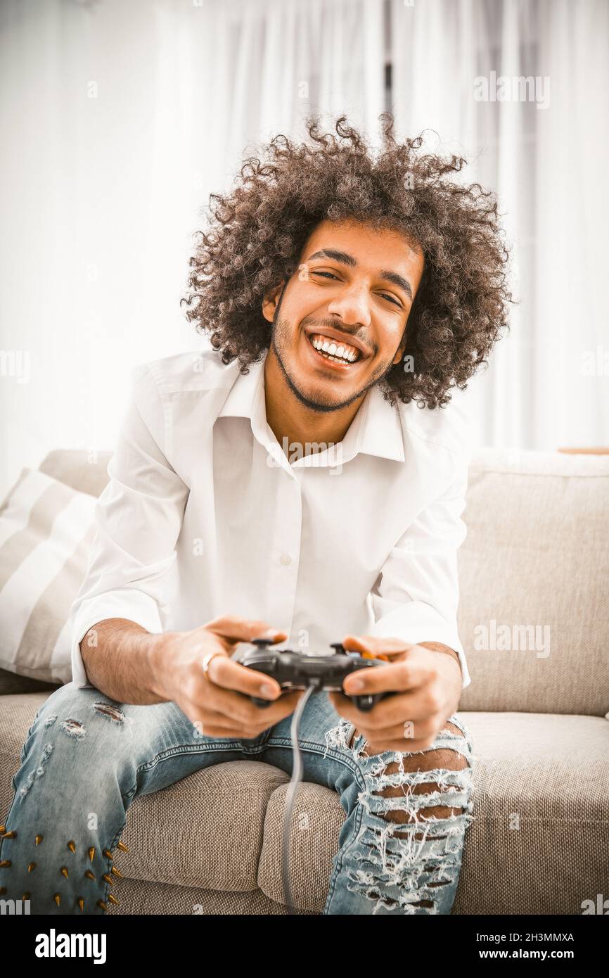 Gamer using controller to play online video games on computer. Man playing  game with joystick and headphones in front of monitor. Player having gaming  equipment, doing fun activity Stock Photo - Alamy