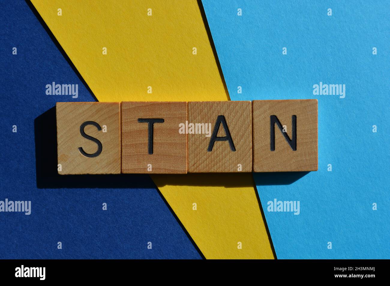 Stan, word in wooden alphabet letters, Generation Z slang for someone who is a super fan of a celebrity's work Stock Photo