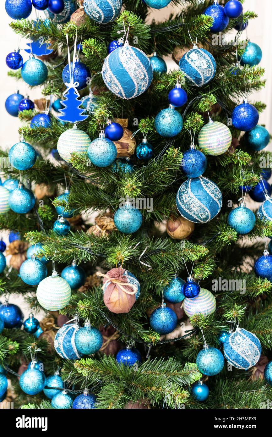 Green Christmas Tree With Beautiful White and Blue Decorations. Stock Photo