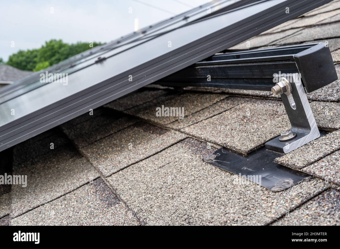Rail, bracket, and anchor to a solar panel installed on a asphalt