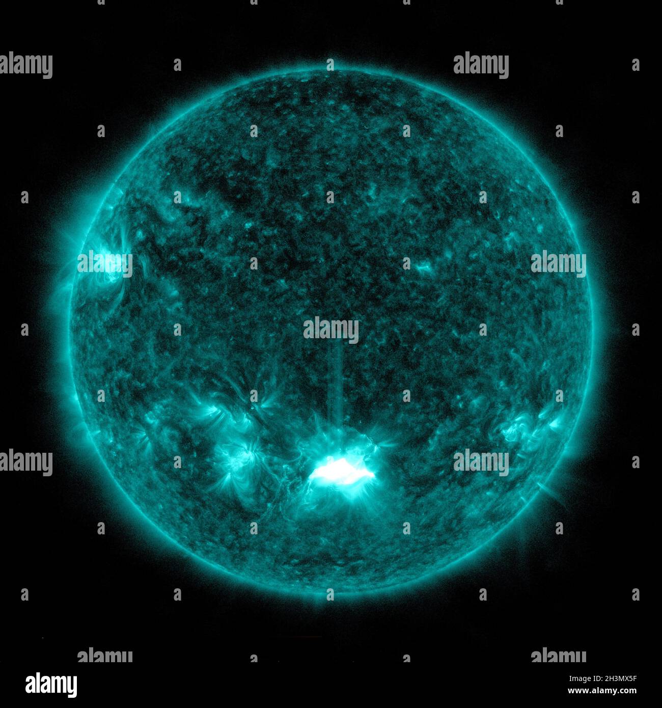 NASA's Solar Dynamics Observatory captured this image of a solar flare, as seen in the bright flash at the Sun's lower center, on October 28, 2021. The image shows a subset of extreme ultraviolet light that highlights the extremely hot material in flares and which is colorized here in teal. Solar flares are powerful bursts of radiation. Harmful radiation from a flare cannot pass through Earth's atmosphere to physically affect humans on the ground; however, when intense enough, they can disturb the atmosphere in the layer where GPS and communications signals travel. NASA/UPI Stock Photo