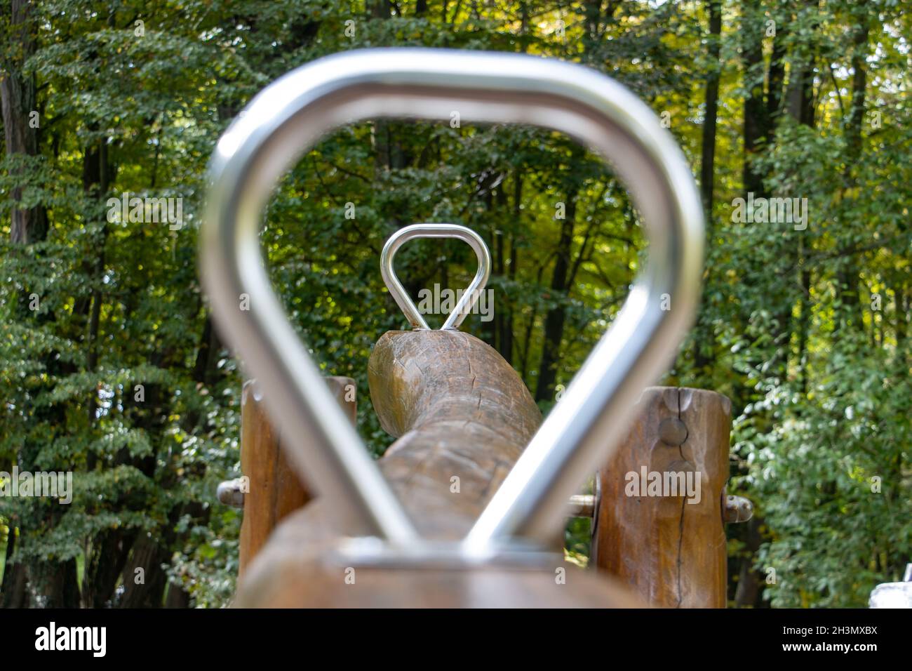 View through the handles of the swing, focused on the back handle Stock Photo