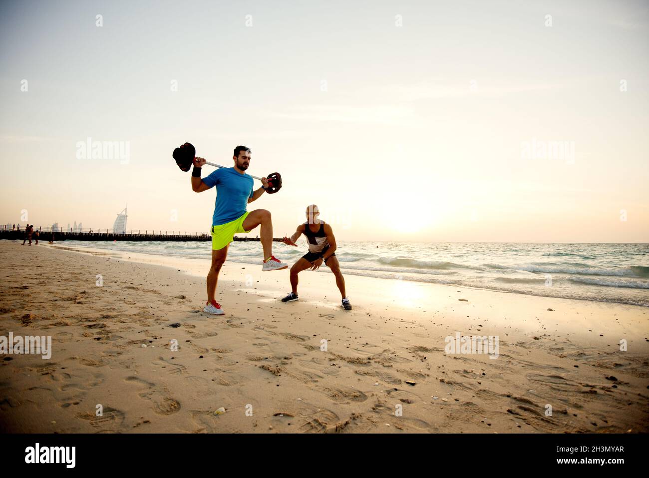 Fitness people at the beach doing exercises Stock Photo - Alamy