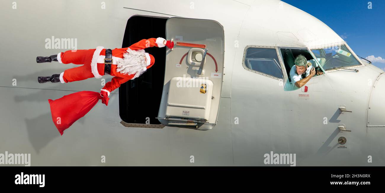 Christmas travel background. model of an airplane with a festive stocking  Stock Photo - Alamy