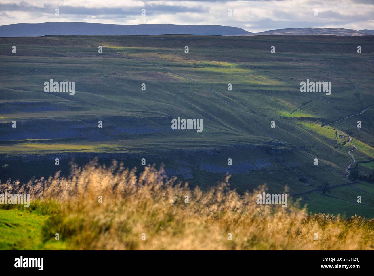 Panoramic view from above Kettlewell in Yorkshire Dales National Park with steep Cam Gill Road in the distance, Wharfedale, North Yorkshire, England Stock Photo
