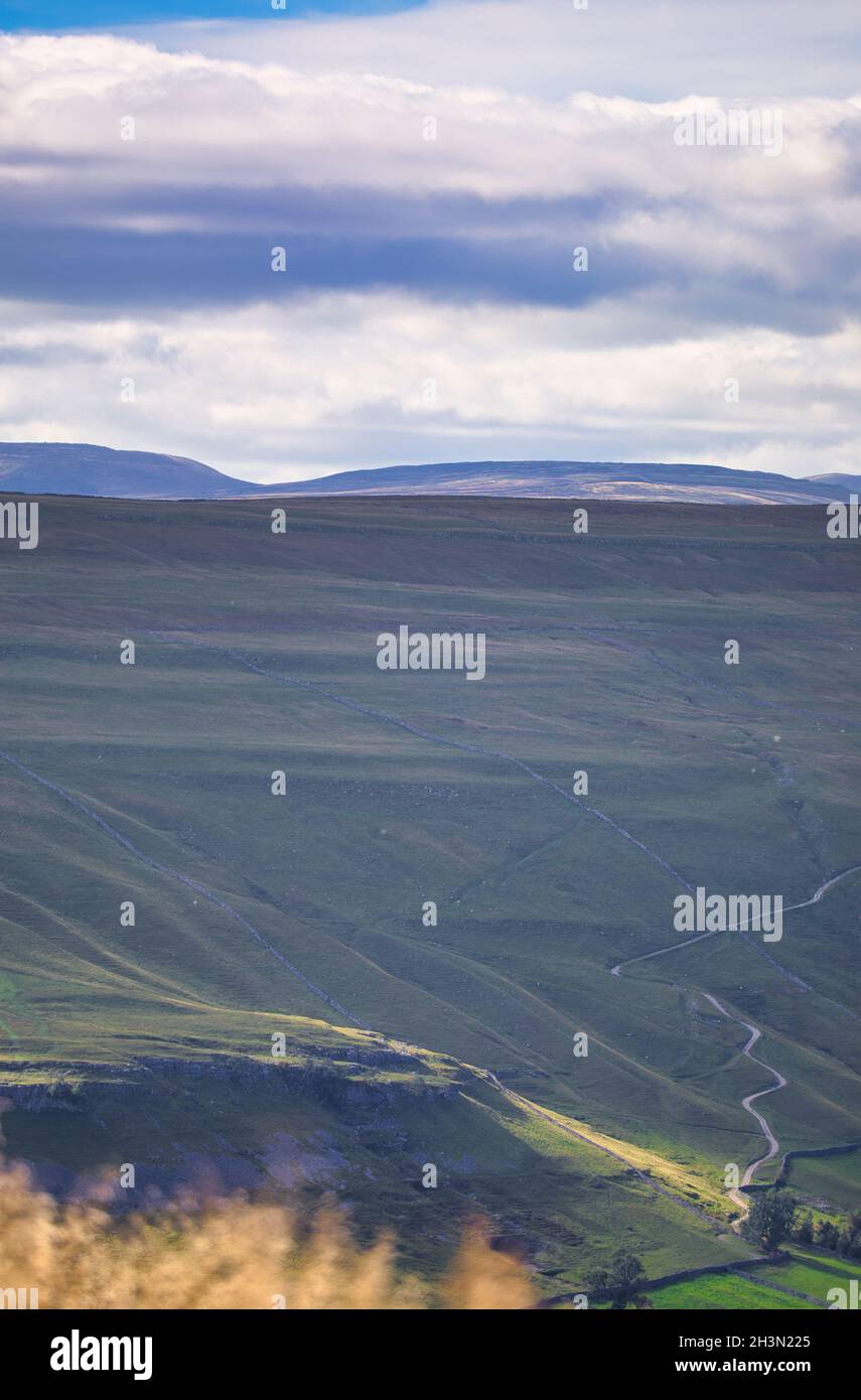 Panoramic view from above Kettlewell in Yorkshire Dales National Park with steep Cam Gill Road in the distance, Wharfedale, North Yorkshire, England Stock Photo