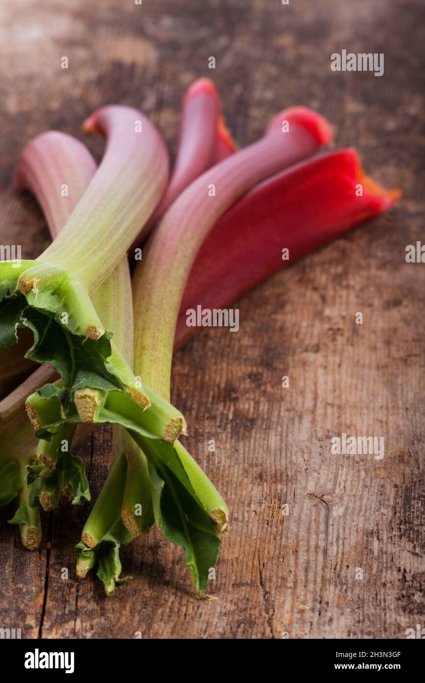 Raw rhubarb on wood Stock Photo
