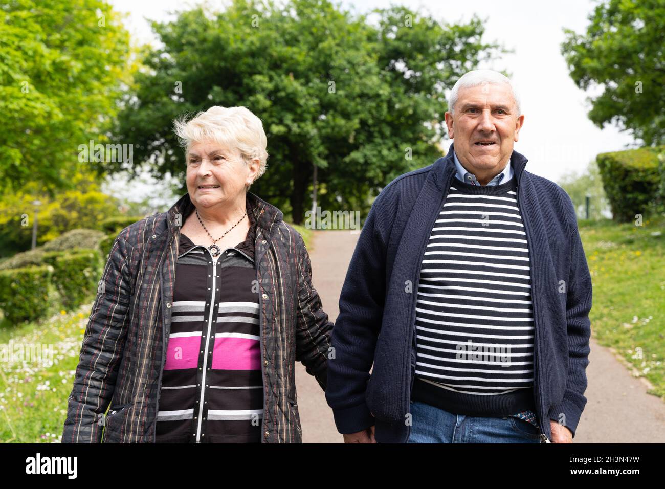 Old man woman walking arm hi-res stock photography and images - Alamy