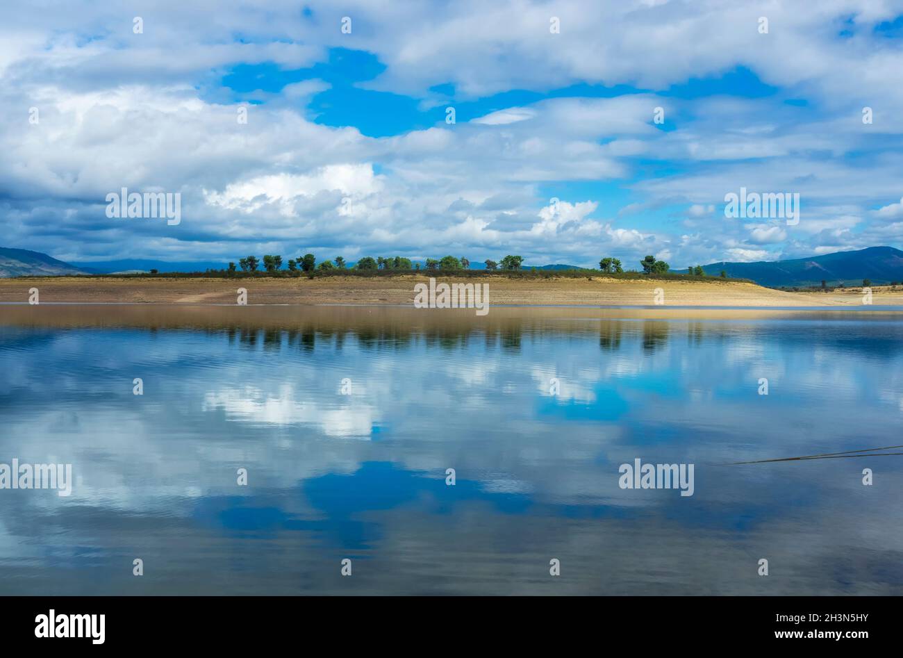 The cloudy sky reflected in the water of the lake Stock Photo - Alamy