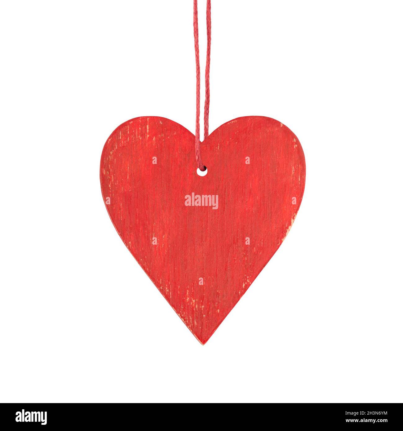 Hanging red wooden heart. Christmas ornament isolated on a white background. Stock Photo
