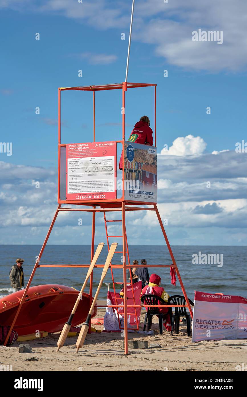 Lifeguard with rescue tower on the beach of the Baltic Sea near Swinoujscie in Poland Stock Photo