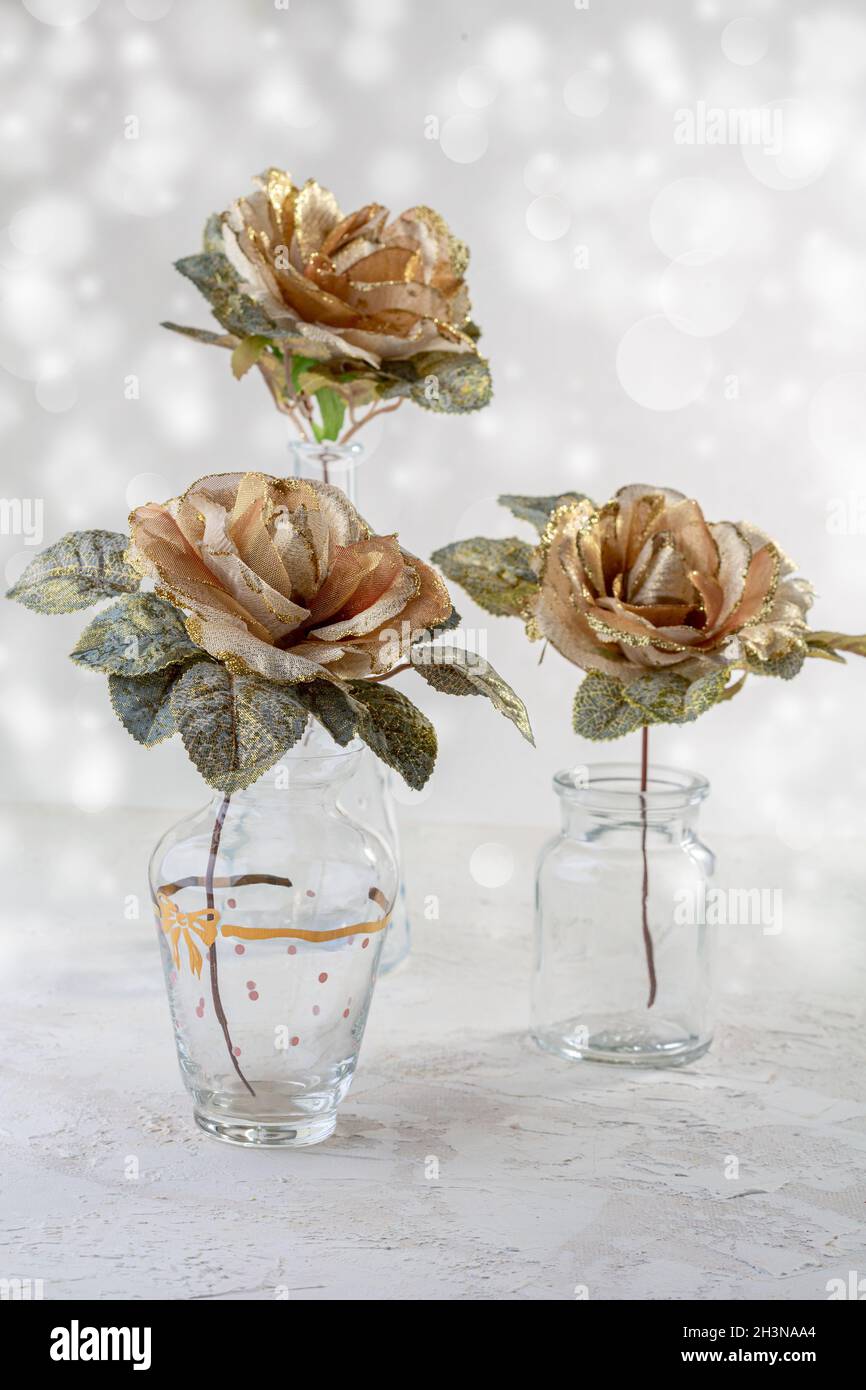 Golden roses in glass vases Stock Photo - Alamy