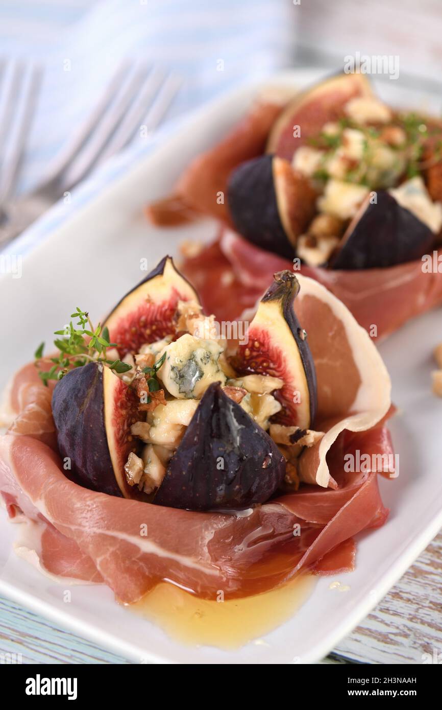 Figs stuffed with blue cheese, wrapped in Parma ham, drizzled with