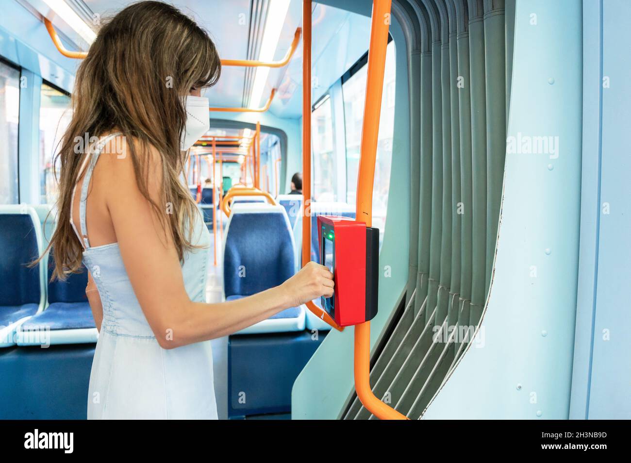 Woman with protective face mask validating electronic ticket in public ...
