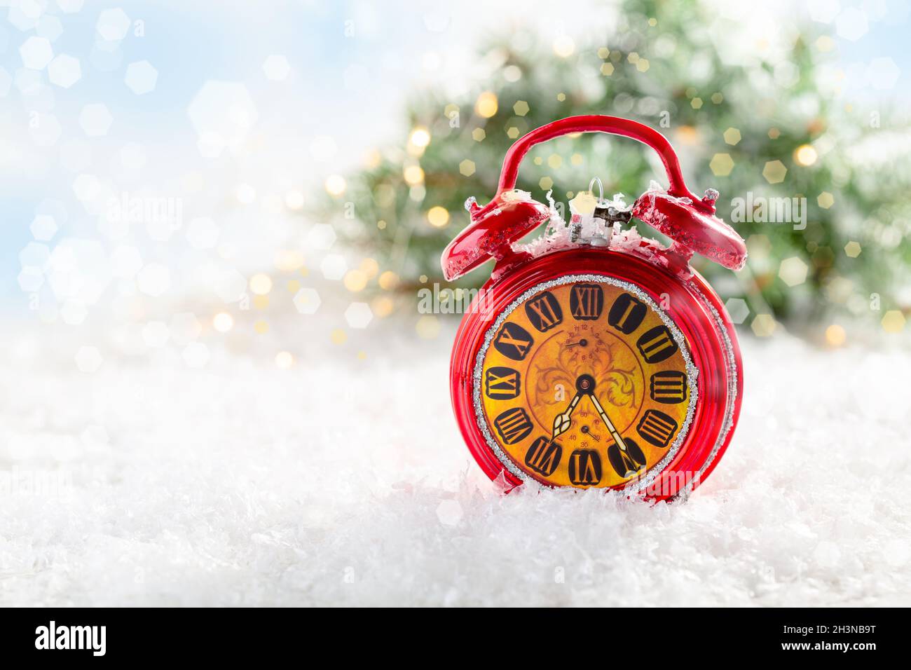 Christmas card with a red alarm clock. Stock Photo
