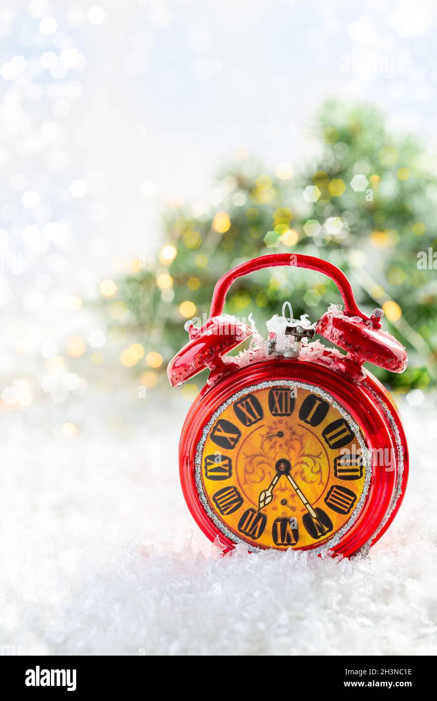 Christmas card with a red alarm clock. Stock Photo