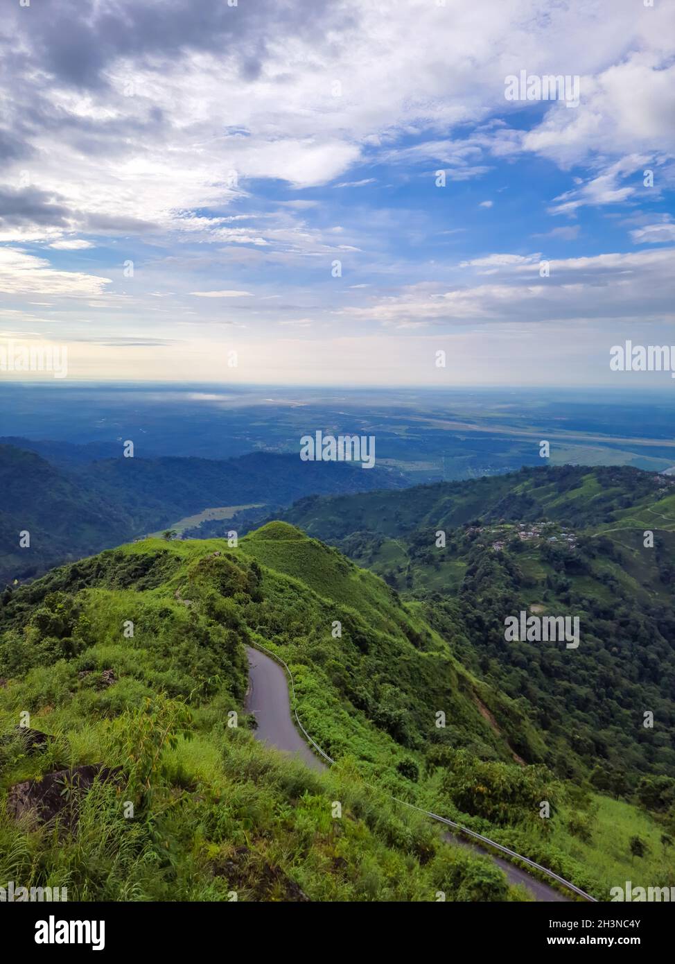green mountain with dramatic sky at morning from hill top image is taken at kurseong darjeeling west bengal india. Stock Photo